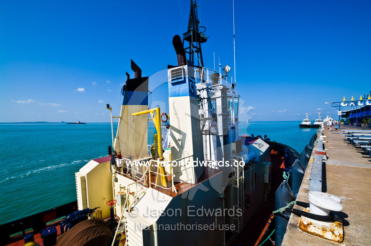 The large chimneys and bridge of a tug boat moored at a marina. Darwin Waterfront, Darwin, Northern Territory, Australia