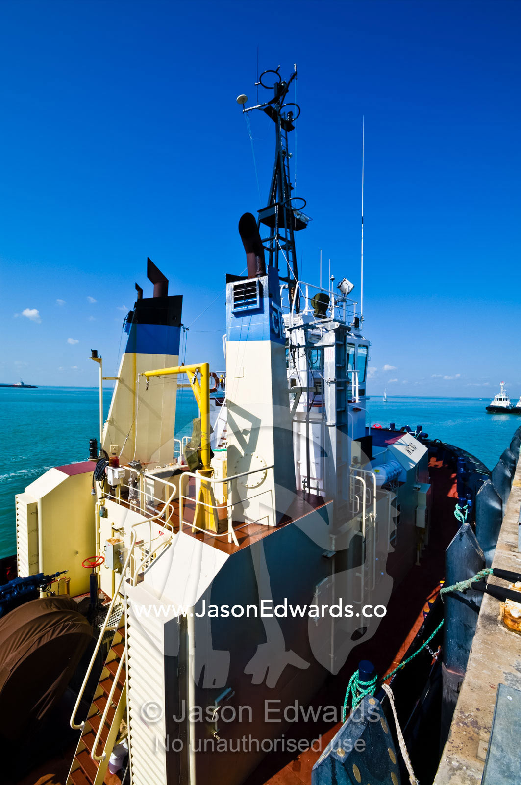 The large chimneys and bridge of a tug boat moored at a marina. Darwin Waterfront, Darwin, Northern Territory, Australia