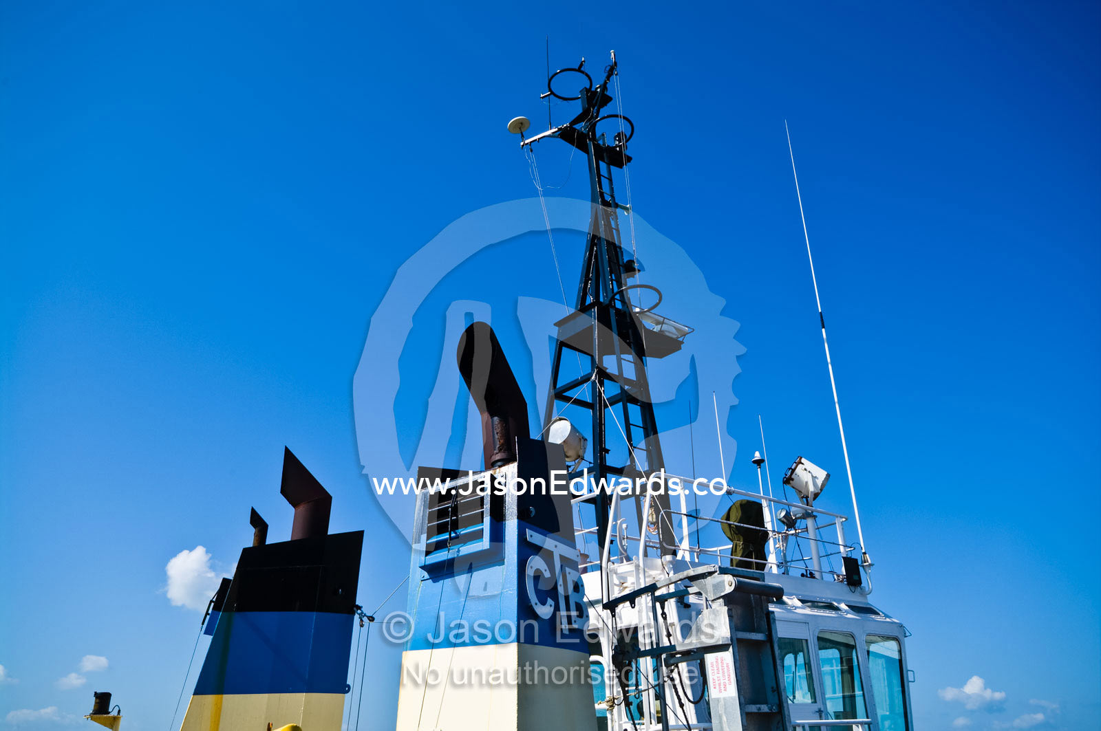 The large chimneys and bridge of a tug boat moored at a marina. Darwin Waterfront, Darwin, Northern Territory, Australia