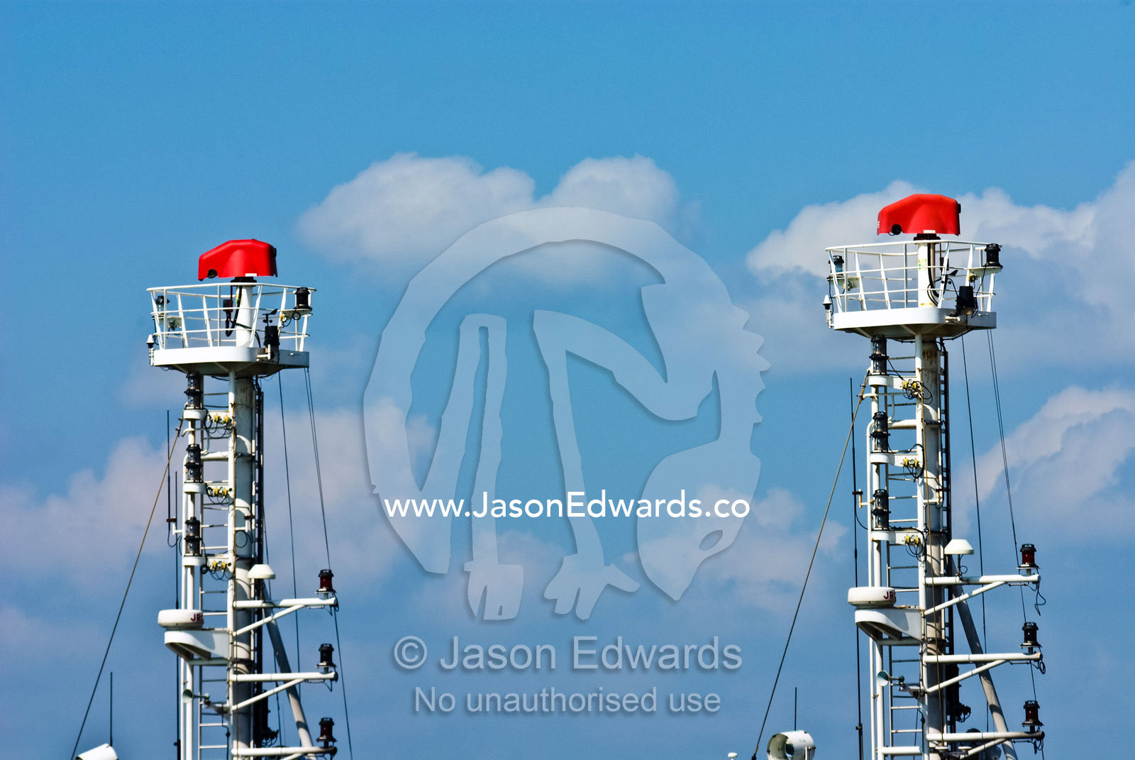 The masts and crows nests of two tug boats moored at a jetty in port. Darwin Waterfront, Darwin, Northern Territory, Australia