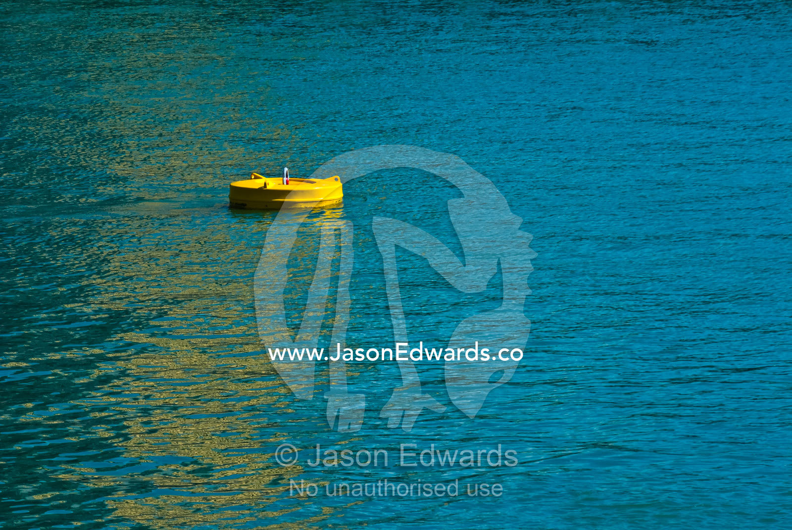 A bright yellow floating mooring buoy provides anchor in a marina. Darwin Waterfront, Darwin, Northern Territory, Australia