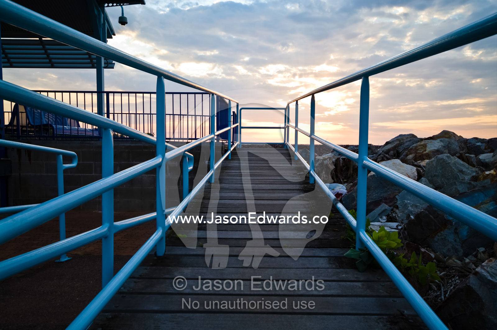 A boardwalk and safety rails lead to a ferry departure lounge. Cullen Bay, Darwin, Northern Territory, Australia