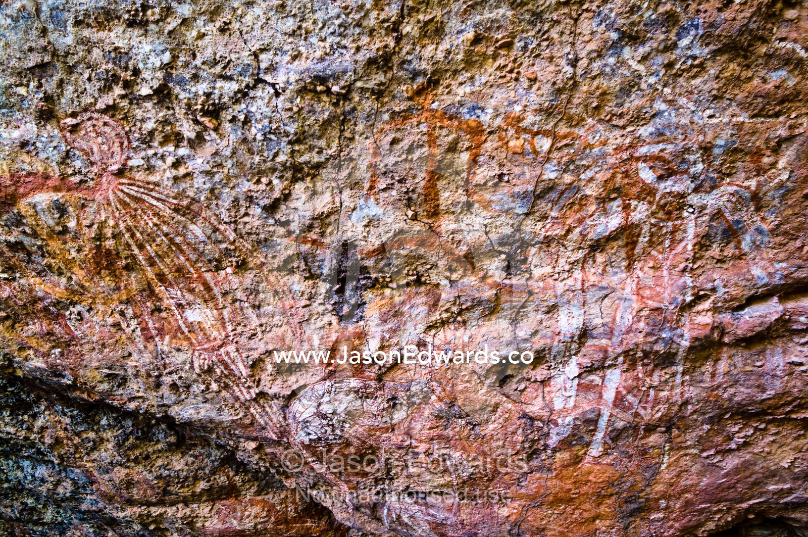 Ancient Aboriginal rock art depicts figures on a cliff cave wall. Nourlangie, Nawurlandja, Anbangbang Billabong, Kakadu National Park, Northern Territory, Australia