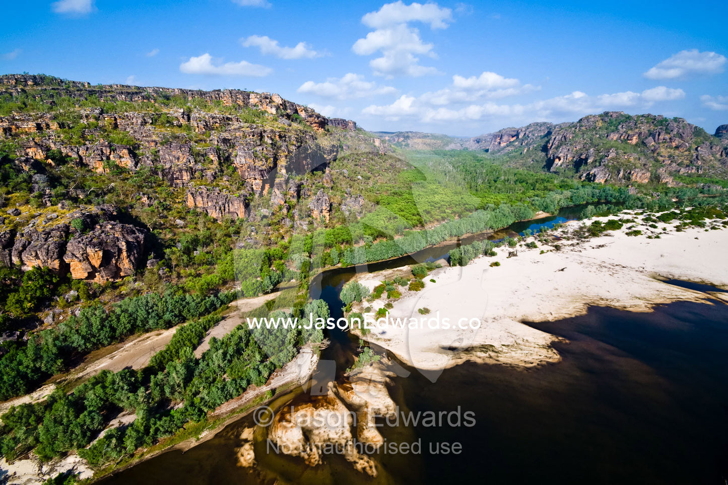 A river deposits large sand beaches at the mouth of a sandstone gorge. East Alligator River, Arnhem Land Border, Kakadu National Park, Northern Territory, Australia.