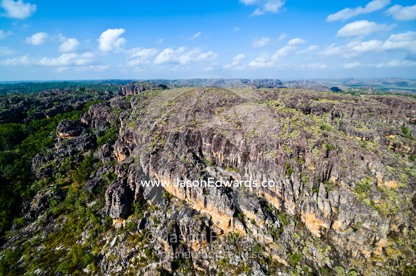 A vast sandstone escarpment and plateau towers over rugged gorges. Arnhem Land Border, Kakadu National Park, Northern Territory, Australia.