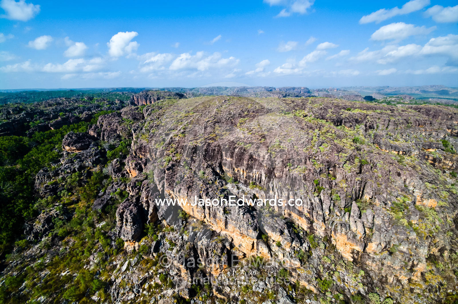 A vast sandstone escarpment and plateau towers over rugged gorges. Arnhem Land Border, Kakadu National Park, Northern Territory, Australia.