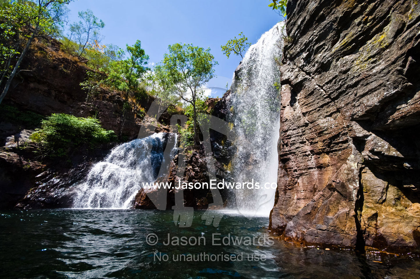 Pristine Florence Falls cascade over a remote sandstone escarpment. Florence Falls, Litchfield National Park, Northern Territory, Australia.