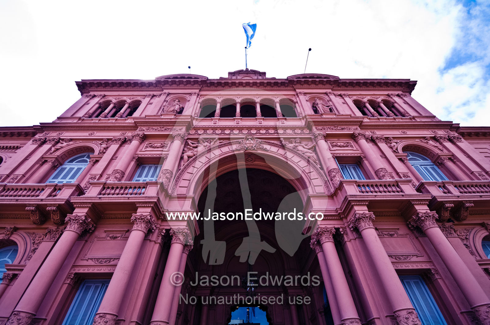 The columned pink facade and Neoclassical portico of the Casa Rosada. Casa Rosada, Plaza de Mayo, Buenos Aires, Argentina.
