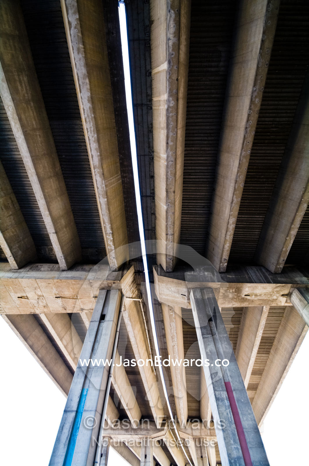 Enormous grey ribbed support vaults of a concrete freeway overpass. La Boca, Buenos Aires, Argentina.