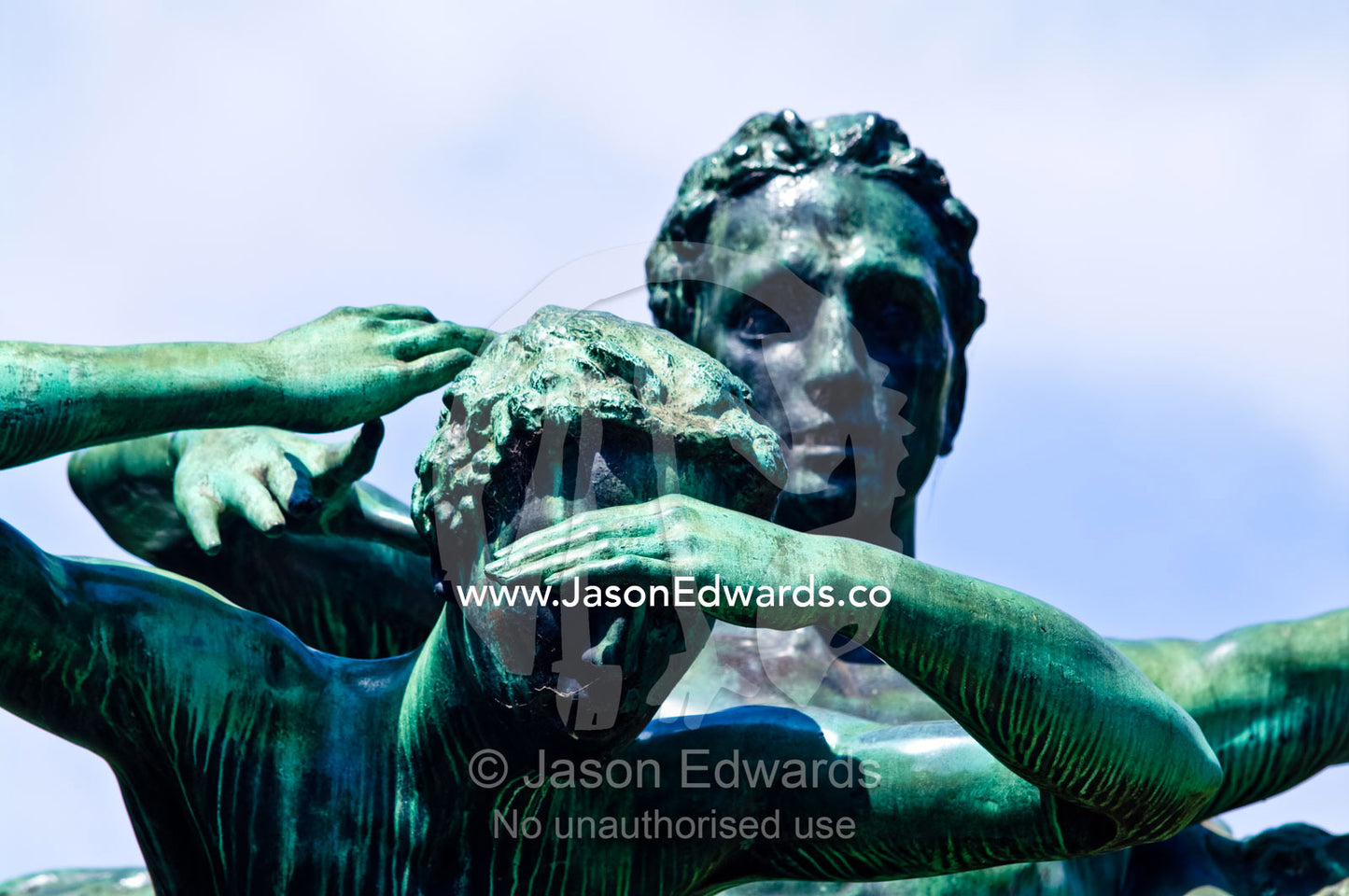 A green figure on the Canto al Trabajo sculpture shields it's eyes. Plaza Eva Peron, Avenue Perseo Colon, San Telmo, Buenos Aires, Argentina.