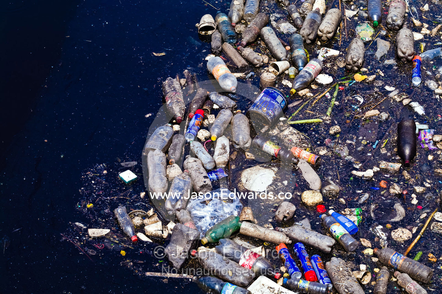 Pollution and plastic bottles floating on the surface of a river. Rocha Bend, Riachuelo River, La Boca, Buenos Aires, Argentina.