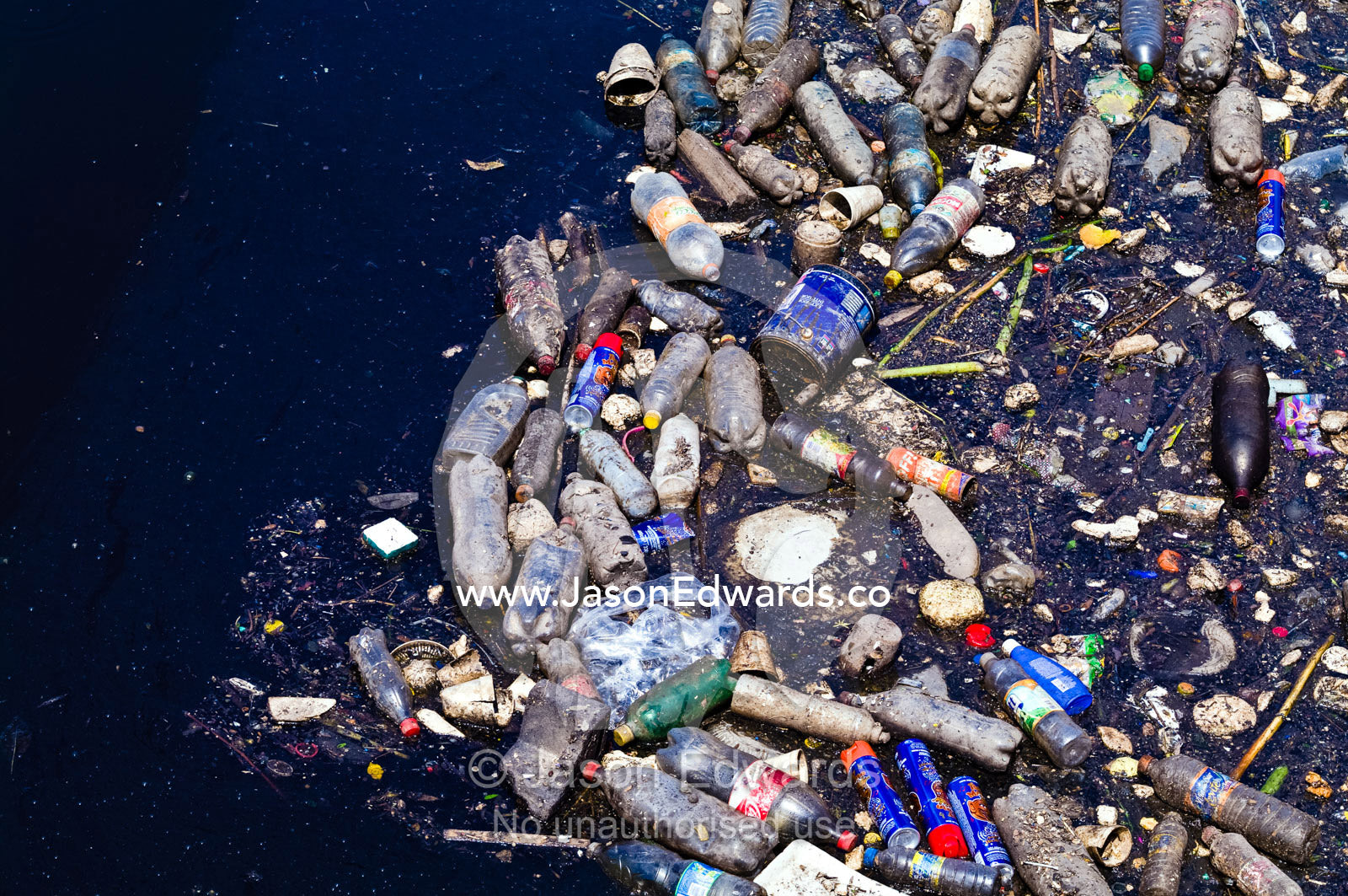 Pollution and plastic bottles floating on the surface of a river. Rocha Bend, Riachuelo River, La Boca, Buenos Aires, Argentina.