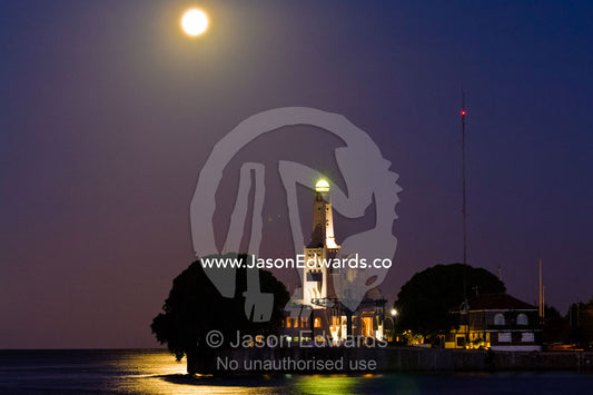 A pastel moonrise over a tree-lined river harbour wall and yacht club. Yacht Club Argentino, Viamonte y R��o de la Plata D��rsena Norte, R��o de la Plata, River of Silver, Puerto Madero, Buenos Aires, Argentina