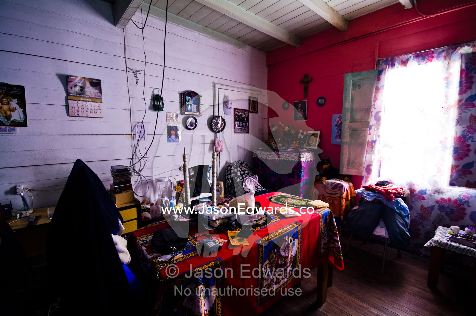 Religious artifacts scattered around a colorful home in a conventillo. La Boca, Buenos Aires, Argentina.