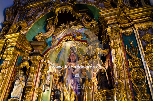 An ornate gold embossed statue of the Virgin Mary and baby Jesus. Our Lady of Pilar Basilica, Recoleta, Buenos Aires, Argentina.