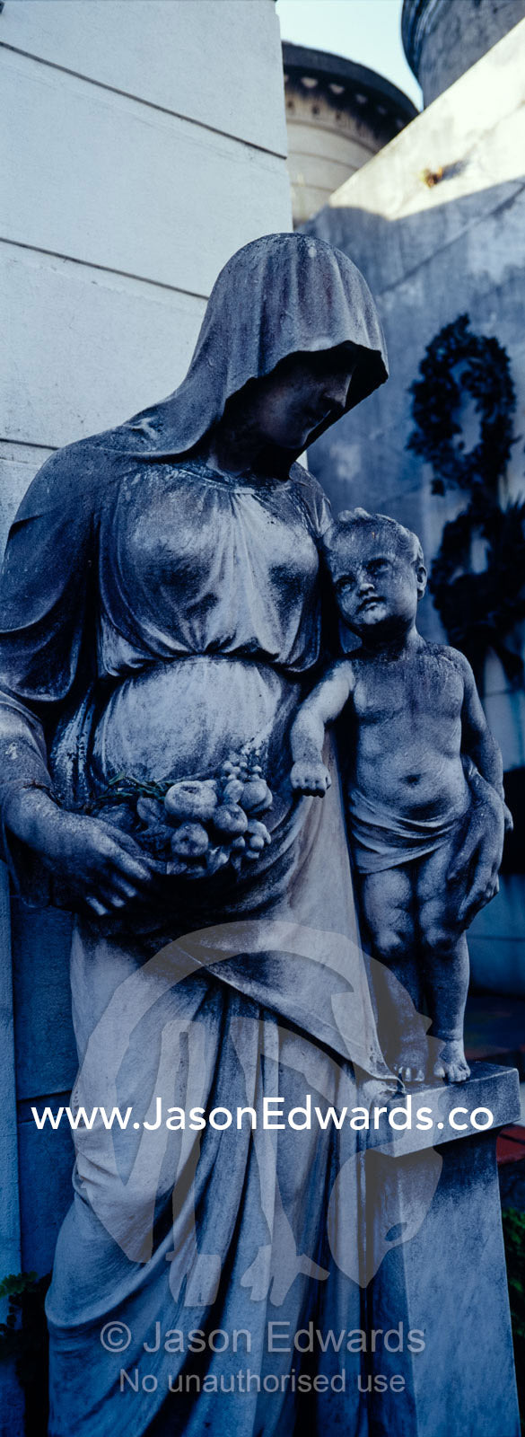 A statue of the Virgin Mary and Jesus Christ at a family mausoleum. La Recoleta Cemetery, Recoleta, Buenos Aires, Argentina.