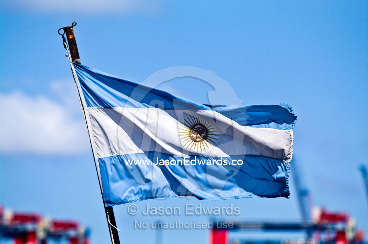 The Argentine flag flaps in the wind from a boat flagpole in the port. La Riachuelo, Little River, La Boca, Buenos Aires, Argentina.