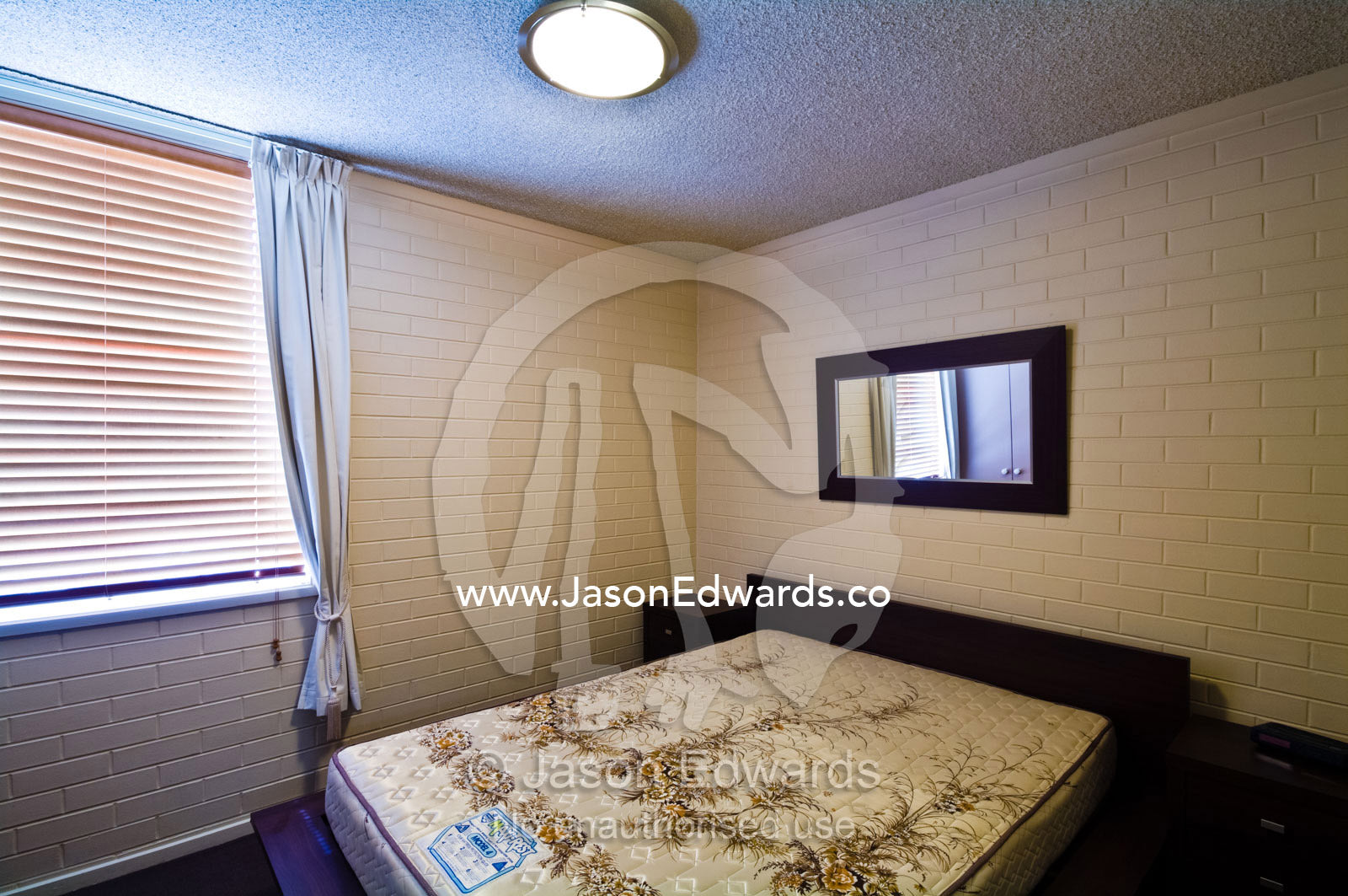 A bare matress in a bedroom in an uninhabited city apartment. North Melbourne, Melbourne, Victoria, Australia.