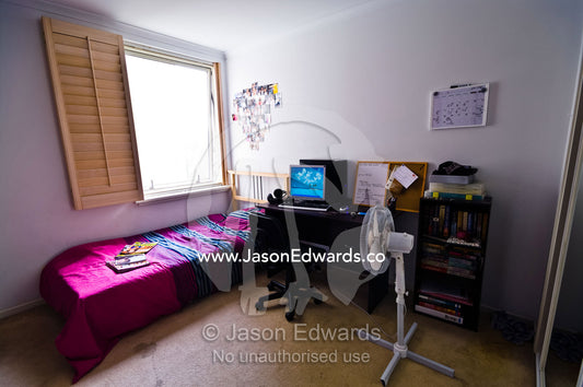 Mismatched bedroom furniture in a student's inner city apartment. St Kilda Road, Melbourne, Victoria, Australia.