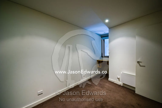An empty bedroom and lightwell in an uninhabited inner city apartment. North Melbourne, Melbourne, Victoria, Australia.
