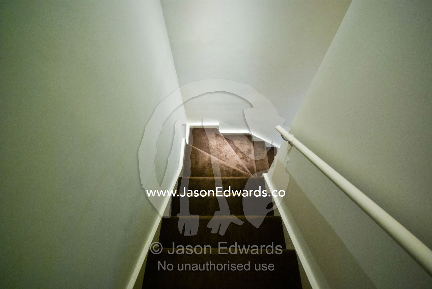 A stairwell descends around a corner in an inner city apartment. North Melbourne, Melbourne, Victoria, Australia.