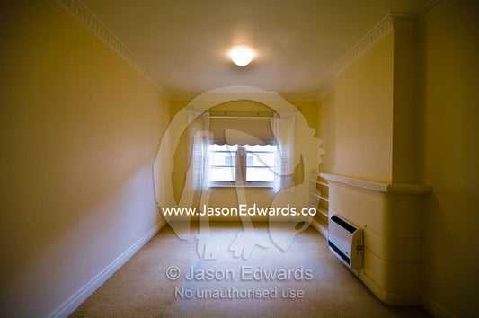 An empty living room in an uninhabited inner city art deco apartment. Parkeville, Melbourne, Victoria, Australia.