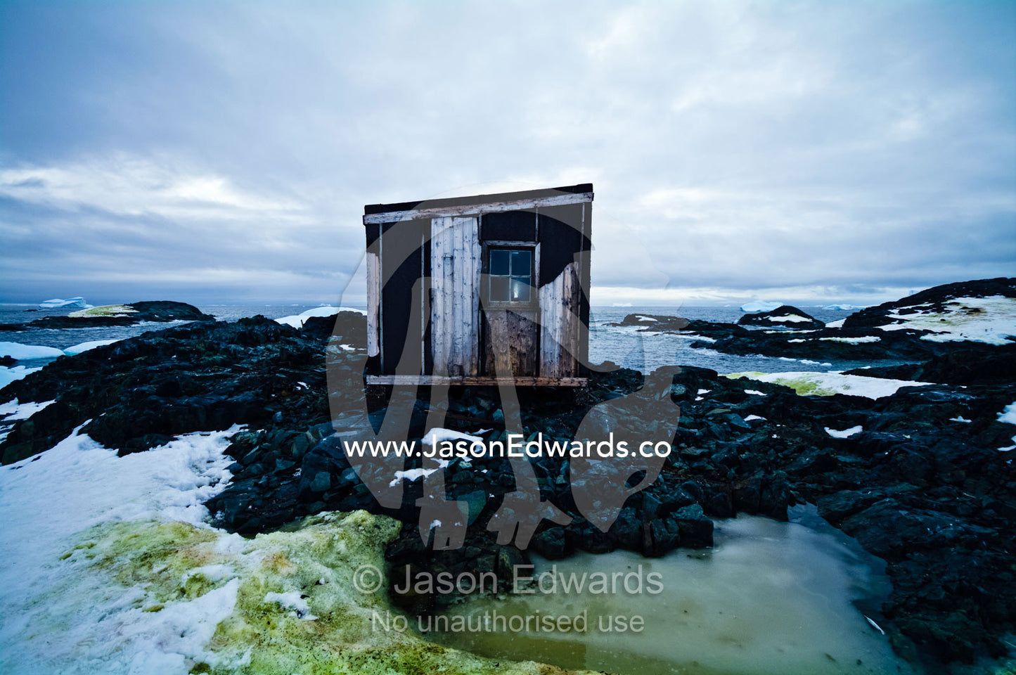 Weathered ruins of an abandoned Antarctic scientific research station. Station W, Detaille Island, Antarctic Peninsula, Antarctic Circle, Antarctica.