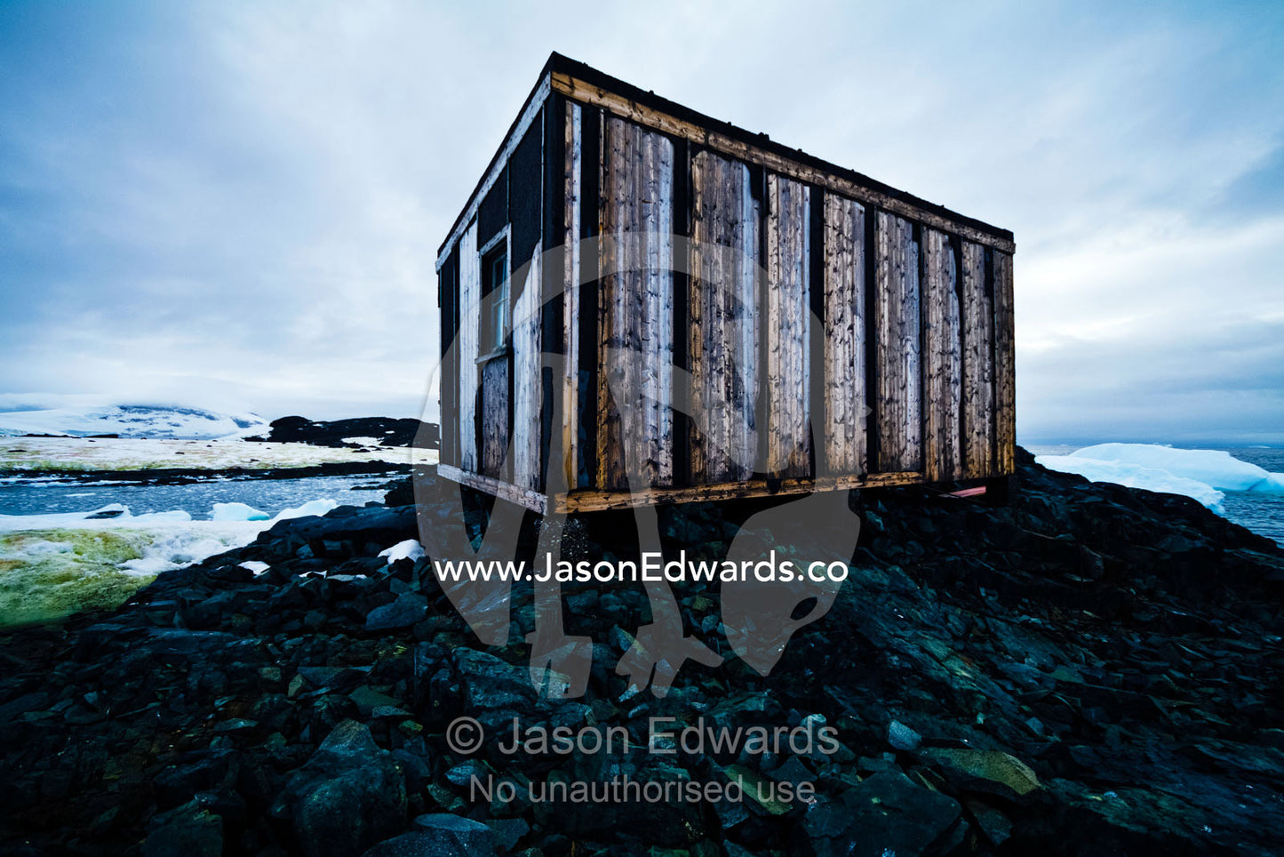 Weathered ruins of an abandoned Antarctic scientific research station. Station W, Detaille Island, Antarctic Peninsula, Antarctic Circle, Antarctica.