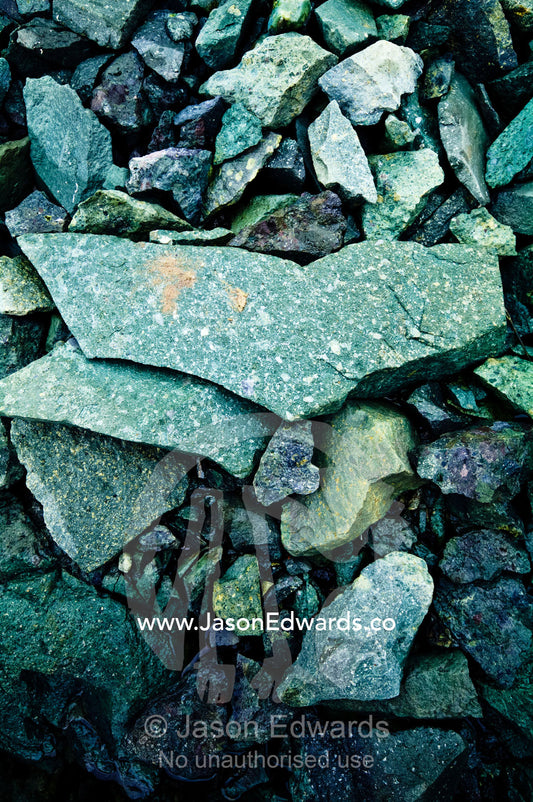 Green granite and shale rocks on a rugged Antarctic island shore. Detaille Island, Antarctic Peninsula, Antarctic Circle, Antarctica.