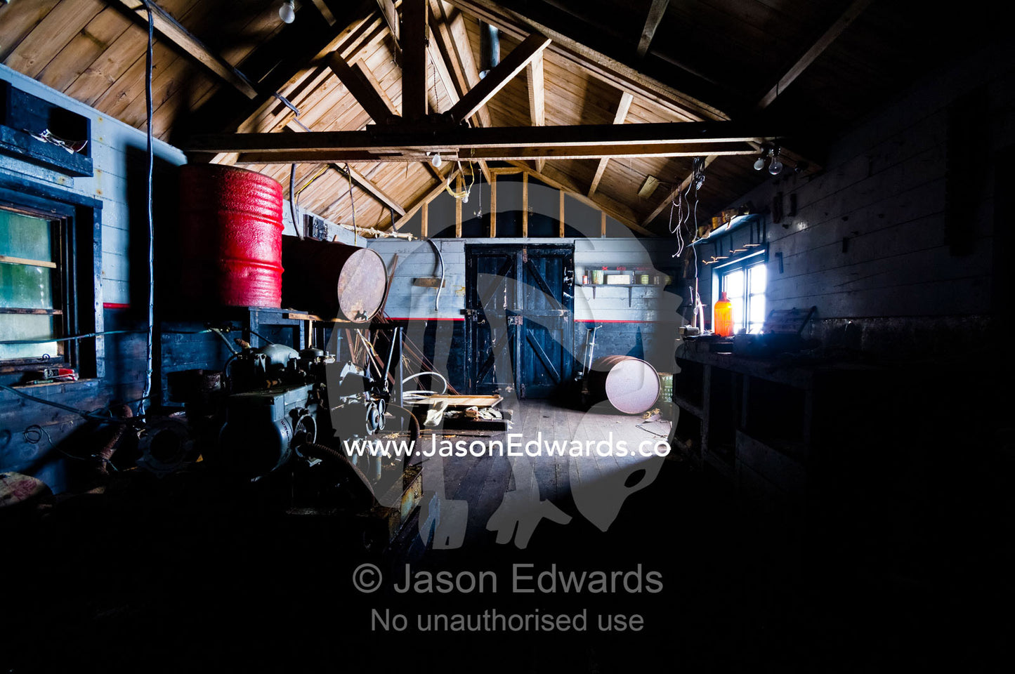 A workshop and oil barrels in an abandoned Antarctic research station. Station W, Detaille Island, Antarctic Peninsula, Antarctic Circle, Antarctica.