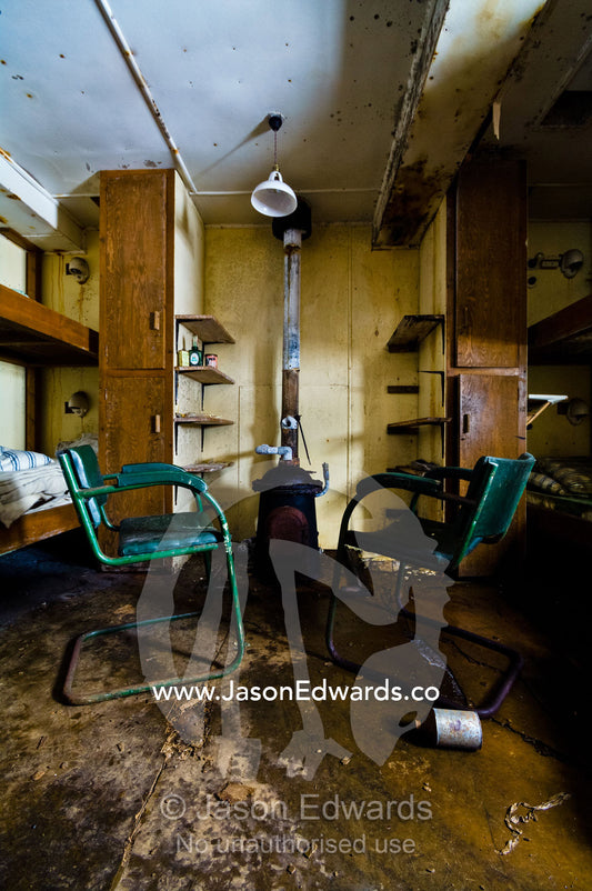 Coal stove in a bunk room in an abandoned Antarctic research station. Station W, Detaille Island, Antarctic Peninsula, Antarctic Circle, Antarctica.