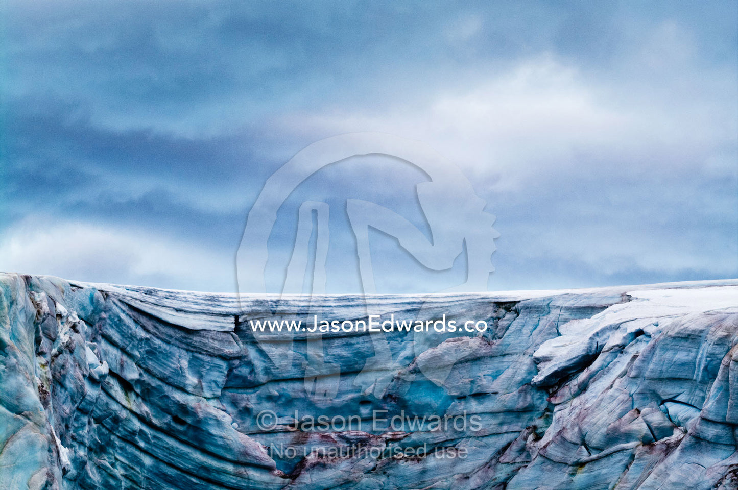 A rugged cold weathered glacier cap with pink Snow Algae, cryoalgae. Galindez Island, Argentine Islands, Faraday Islands, Antarctic Peninsula, Antarctica.