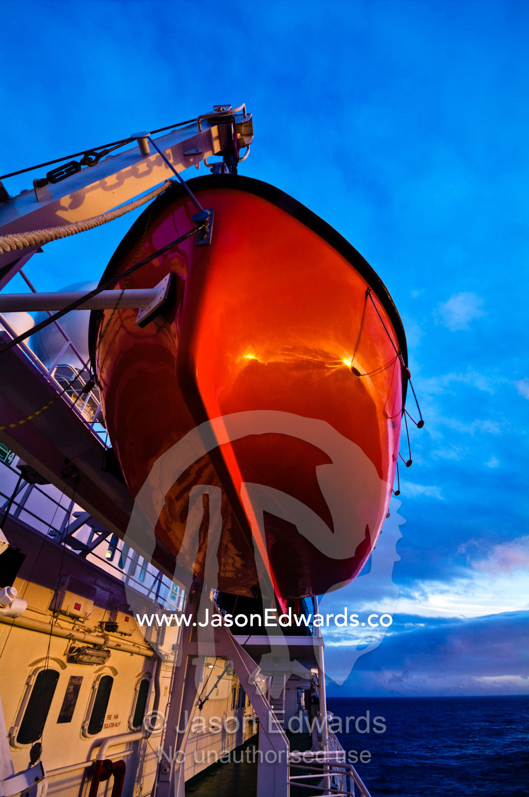 A bright orange emergency rescue lifeboat on a ship in Antarctica. Bransfield Strait, Deception Island, South Shetland Islands, Antarctica.
