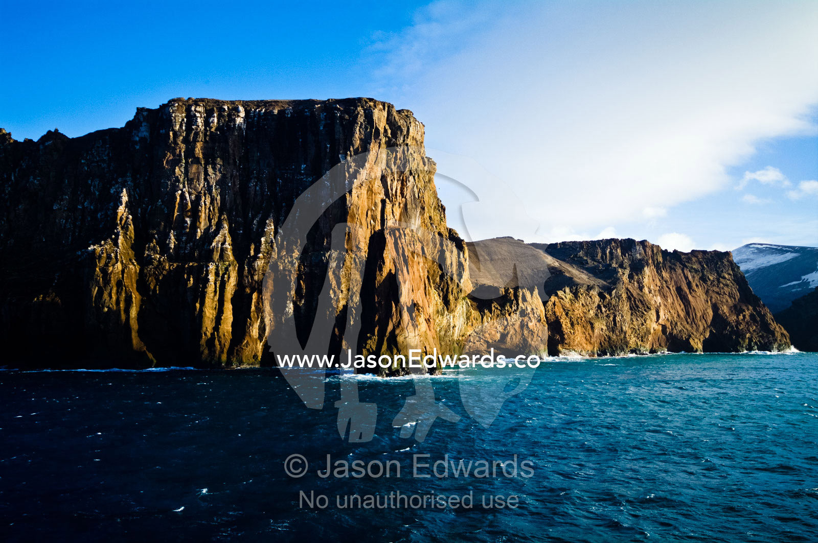 A rugged cliff face and escarpment surrounding a volcanic caldera. Neptune's Bellows, Deception Island, South Shetland Islands, Antarctic Peninsula, Antarctica.
