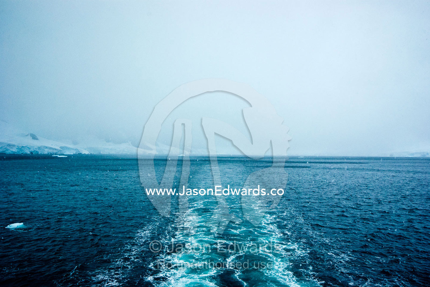 The wake of an ecotourism ship as it passes between an ice passage. Gerlache Strait, Graham Land, Antarctic Peninsula, Antarctica.