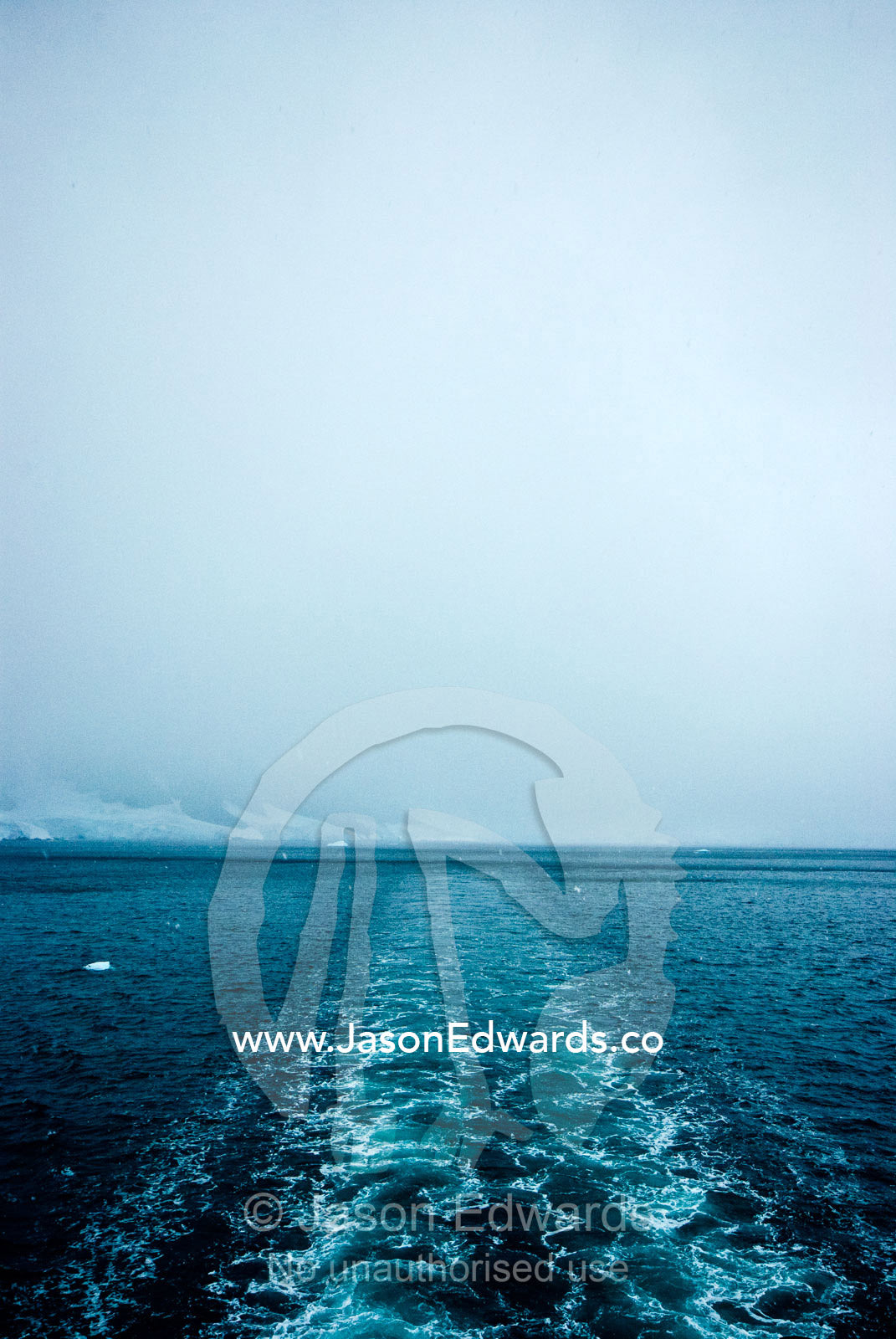 The wake of an ecotourism ship as it passes between an ice passage. Gerlache Strait, Graham Land, Antarctic Peninsula, Antarctica.