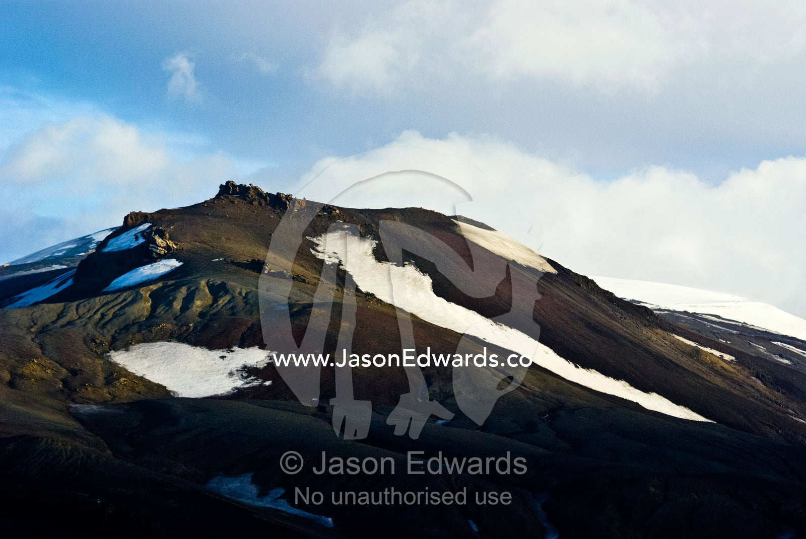Rugged snow and ice encrusted mountain surrounding a volcanic caldera. Neptune's Bellows, Deception Island, South Shetland Islands, Antarctic Peninsula, Antarctica.