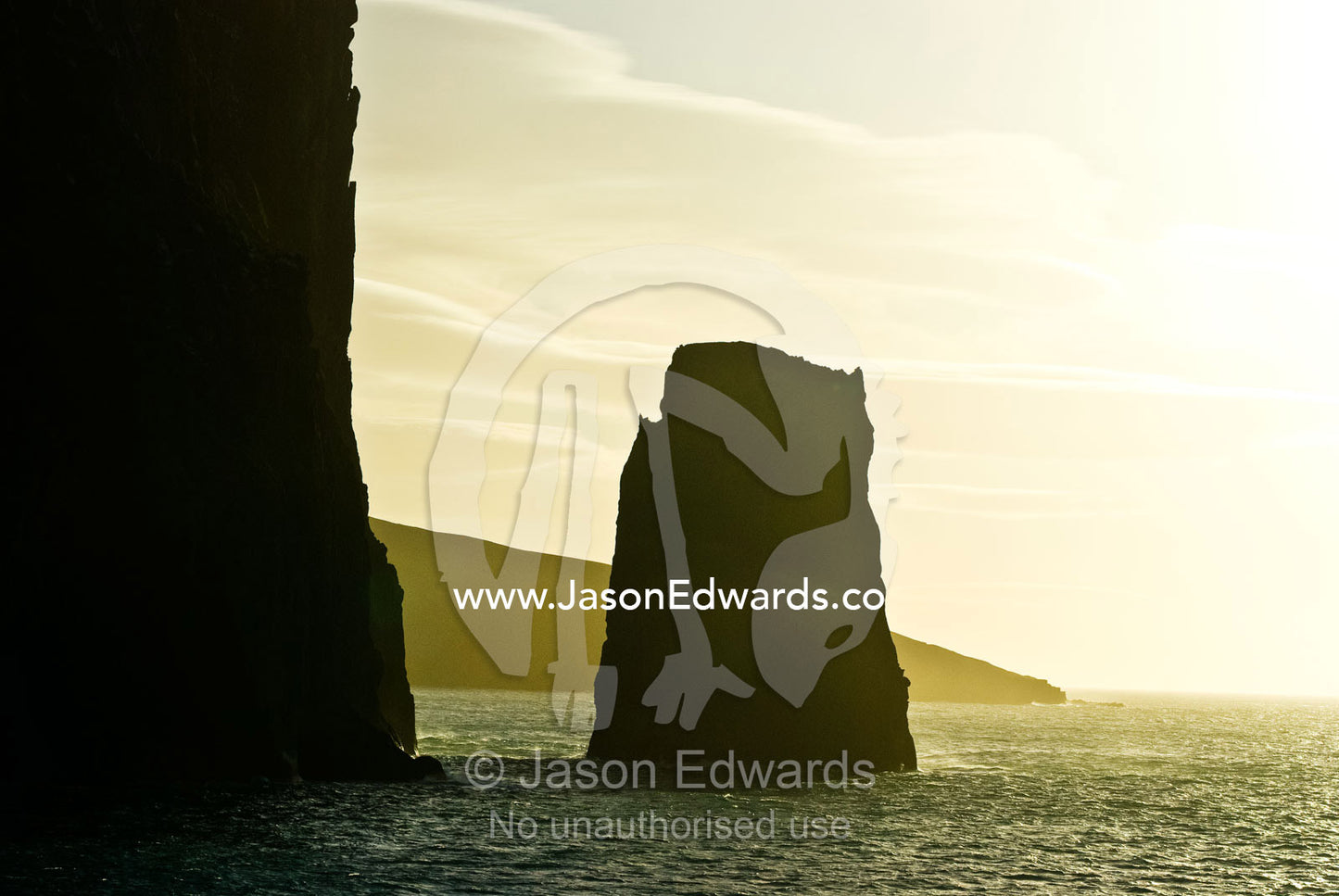 A rugged cliff face and pinnacle rock near a volcanic caldera. Bransfield Strait, Neptune's Bellows, Deception Island, South Shetland Islands, Antarctic Peninsula, Antarctica.