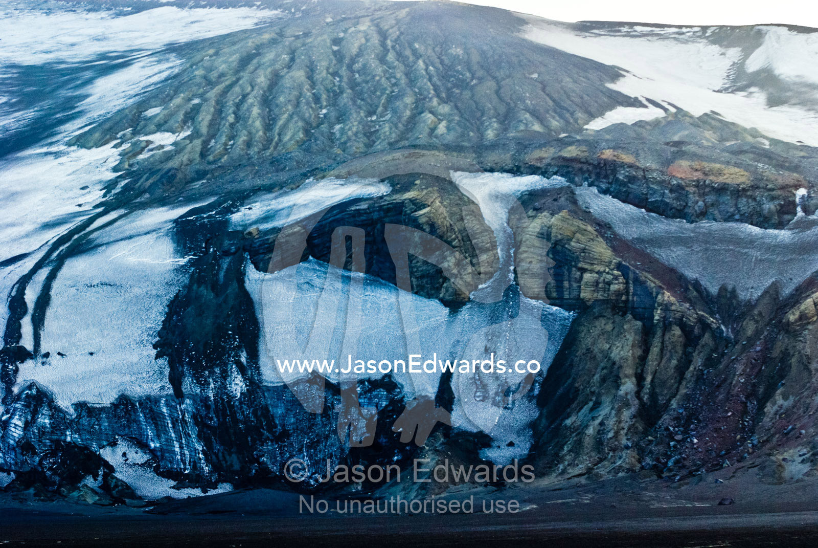 A harsh and inhospitable icy mountainside after a volcanic lahar. Whalers Bay, Port Foster, Deception Island, South Shetland Islands, Antarctic Peninsula, Antarctica.