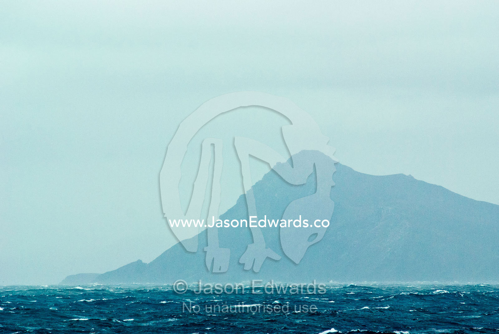 The treacherous headland of Cape Horn rises above the Drake Passage. Cape Horn, Tierra del Fuego, Hornos Island, Chile. The Drake Passage between the Atlantic Ocean and Pacific Ocean.
