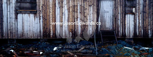 The weathered timbers of an abandoned scientific research station. Station W, Detaille Island, Antarctic Peninsula, Antarctic Circle, Antarctica.