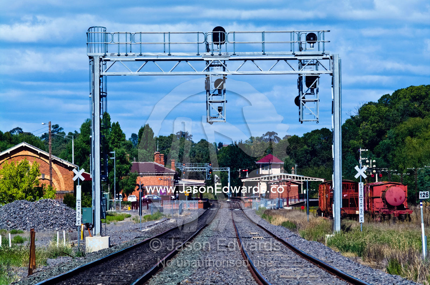 Looking down a railway track leading into a country town station. Castlemaine, Victoria, Australia.