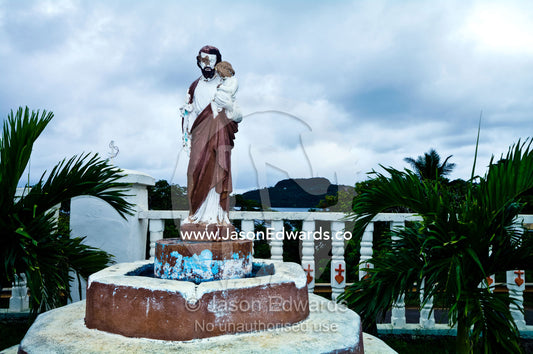 A weathered statue of Christ at St Joseph's Cathedral Catholic Church. Port of Refuge, Neiafu, Vava'u Island Group, Pacific Ocean, Oceania, Kingdom of Tonga.