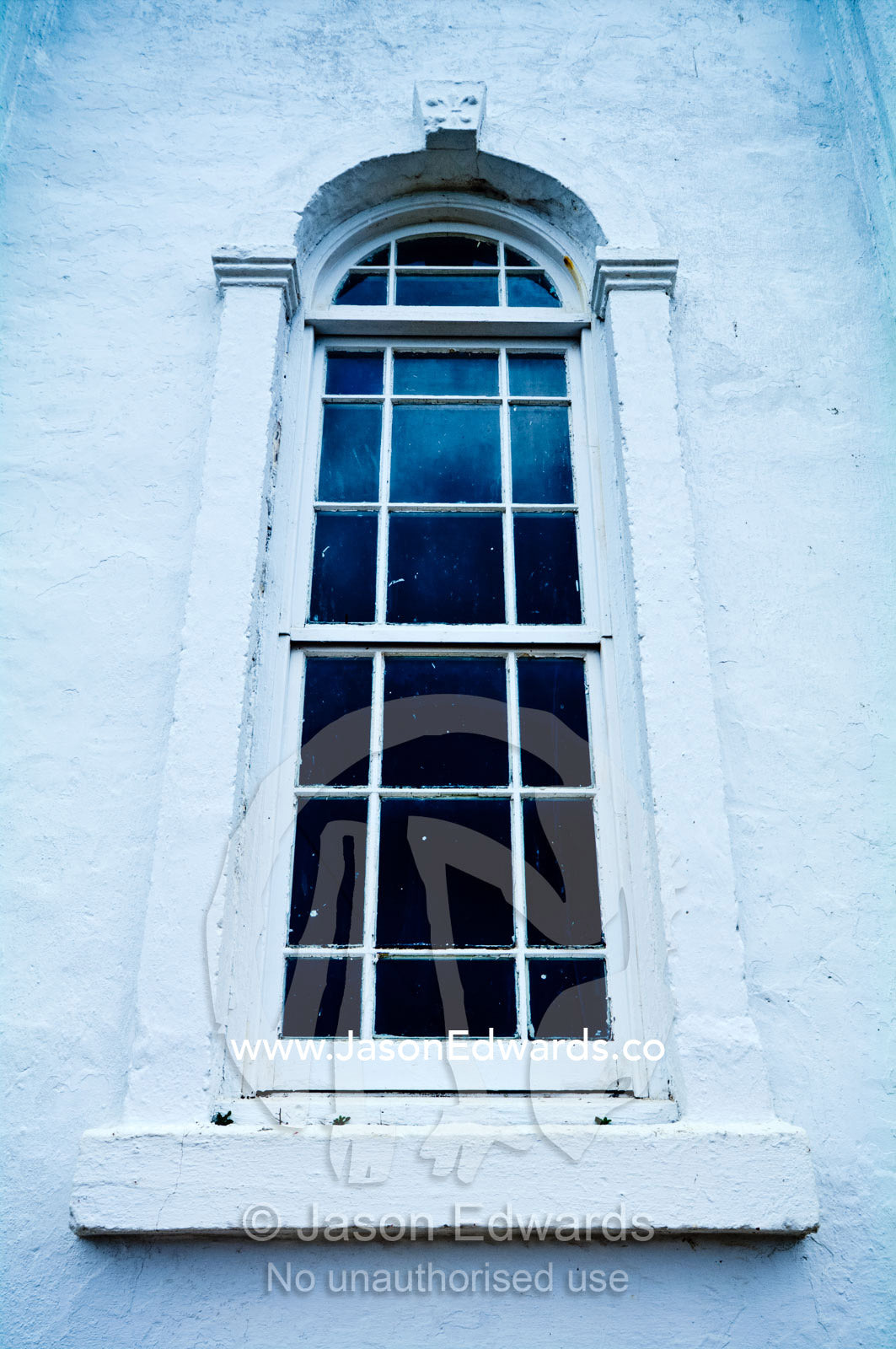 An arched window and panes at St Joseph's Cathedral Catholic Church. Port of Refuge, Neiafu, Vava'u Island Group, Pacific Ocean, Oceania, Kingdom of Tonga.