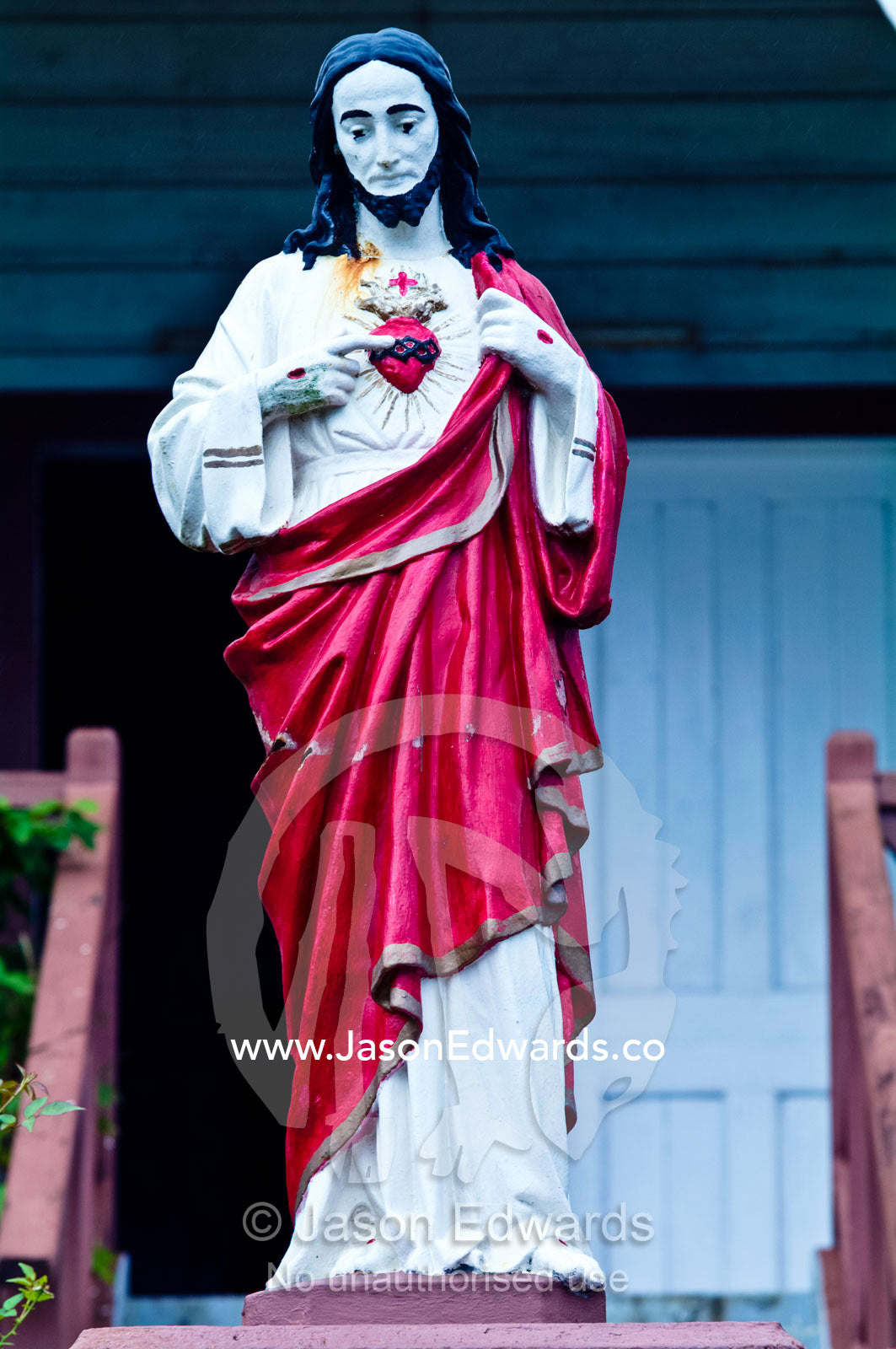 A red-robed statue Christ at St Joseph's Cathedral Catholic Church. Port of Refuge, Neiafu, Vava'u Island Group, Pacific Ocean, Oceania, Kingdom of Tonga.
