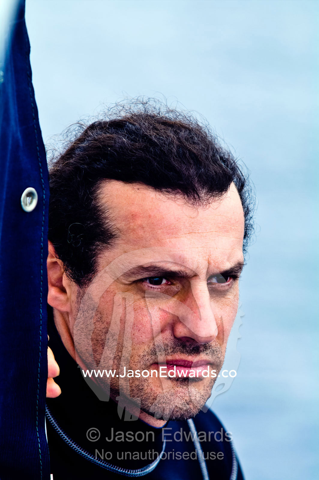 An unshaven man searches the horizon whilst whale watching from a boat Vava'u Island Group, Pacific Ocean, Oceania, Kingdom of Tonga.