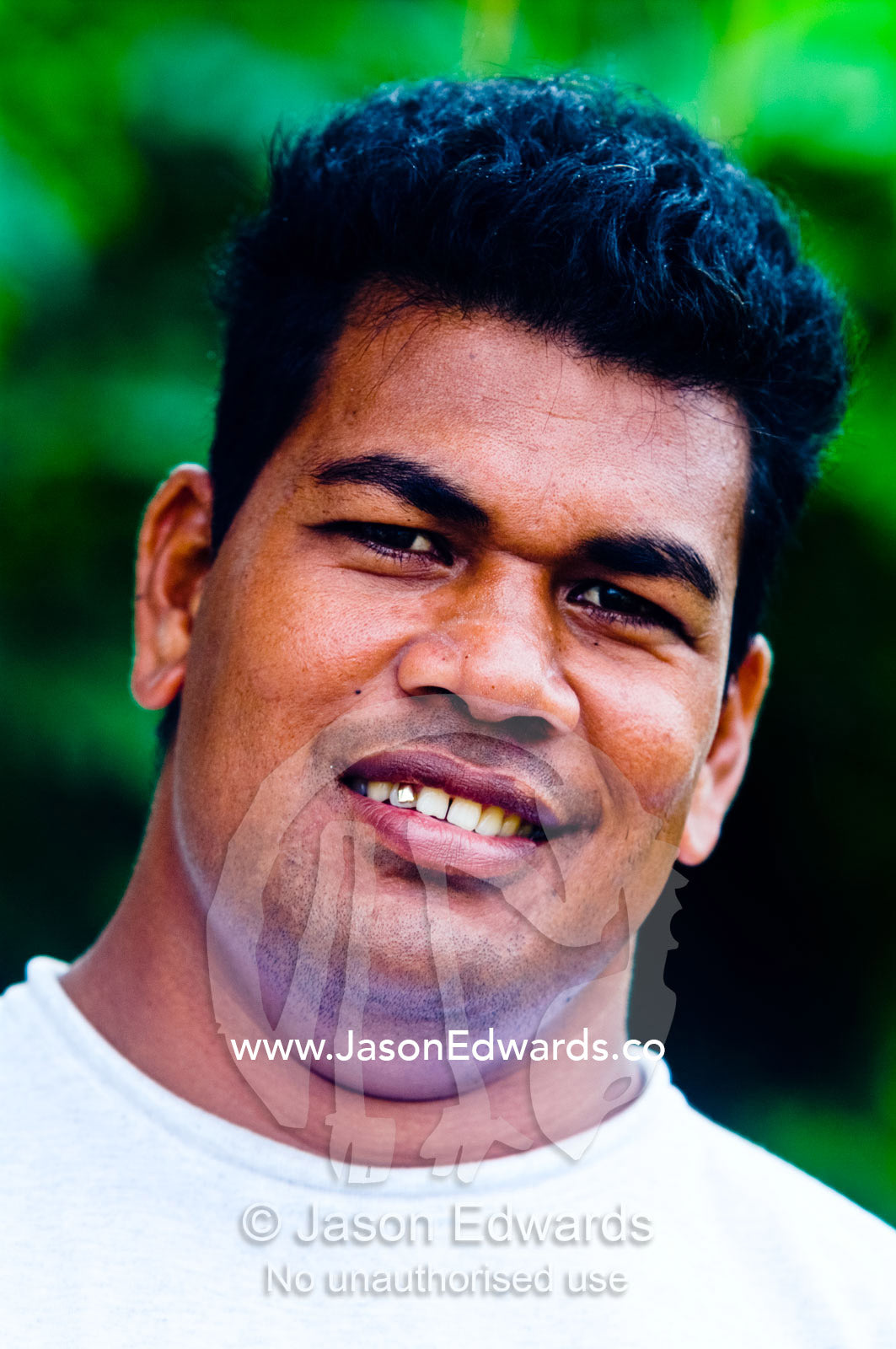 A smiling well-groomed Tongan man after a shave and a haircut. Port of Refuge, Neiafu, Vava'u Island Group, Pacific Ocean, Oceania, Kingdom of Tonga.
