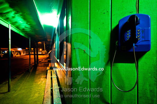 A telephone on the wall of a dilapidated store in main street at night Port of Refuge, Neiafu, Vava'u Island Group, Pacific Ocean, Oceania, Kingdom of Tonga.