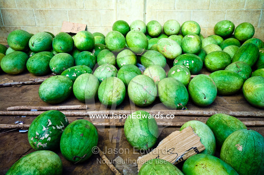 Rows of fresh ripe watermelons for sale in a rural market. Utukalongalu Market, Port of Refuge, Neiafu, Vava'u Island Group, Pacific Ocean, Oceania, Kingdom of Tonga.