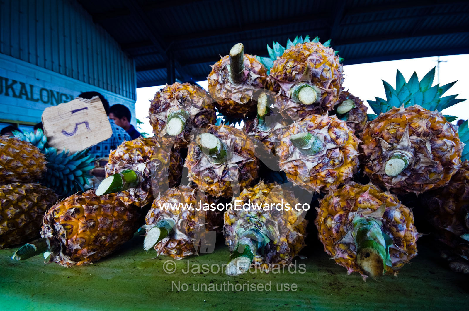 A stack of healthy ripe fresh pineapples for sale at a rural market. Utukalongalu Market, Port of Refuge, Neiafu, Vava'u Island Group, Pacific Ocean, Oceania, Kingdom of Tonga.
